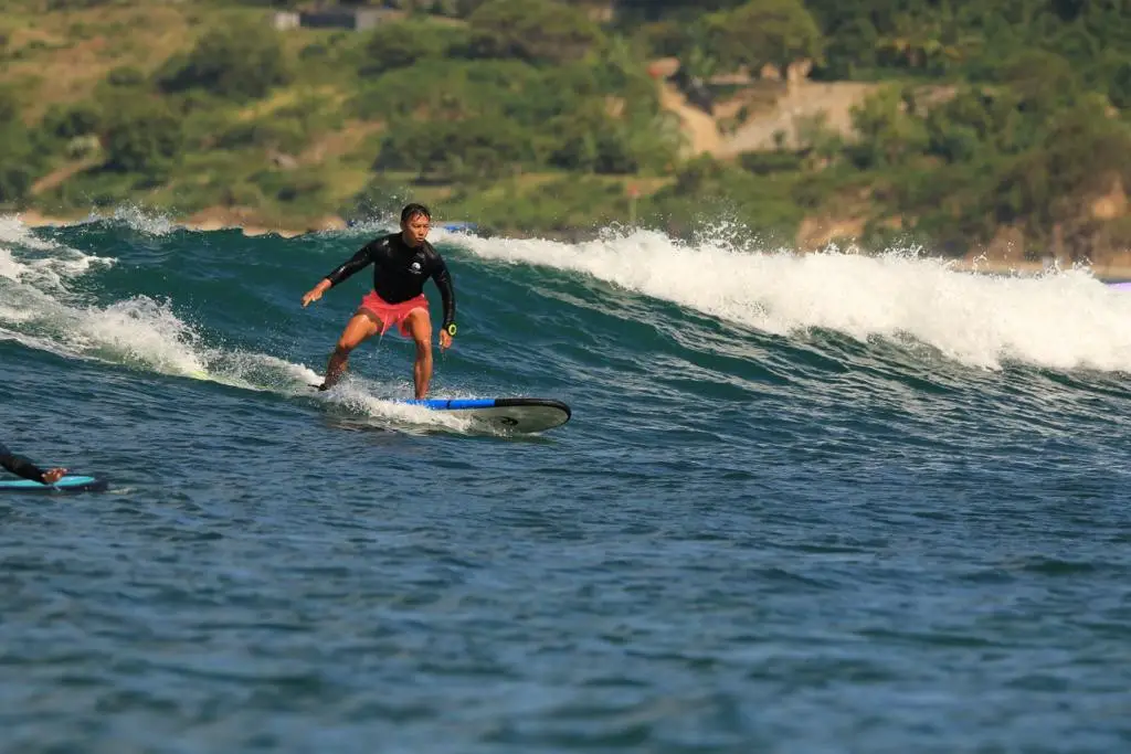 surf in lombok indonesia, catching a wave